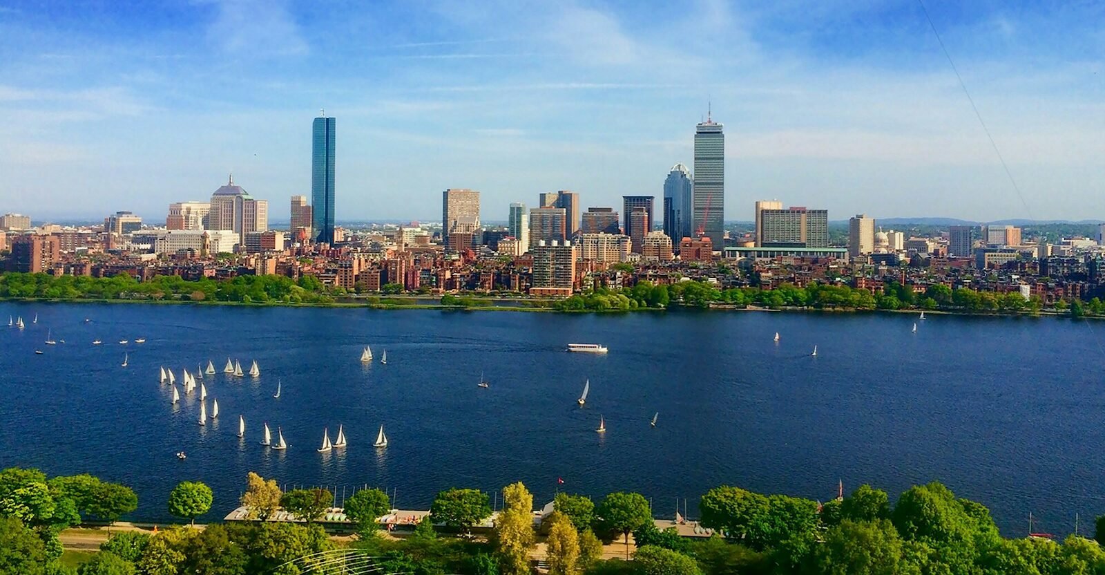 body of water near cityscape at daytime