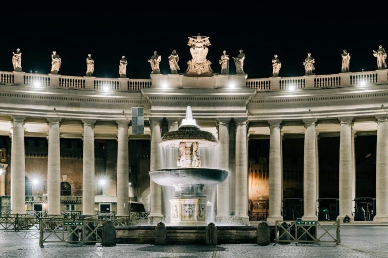 Saint Peter Square water fountain in front of building during night time