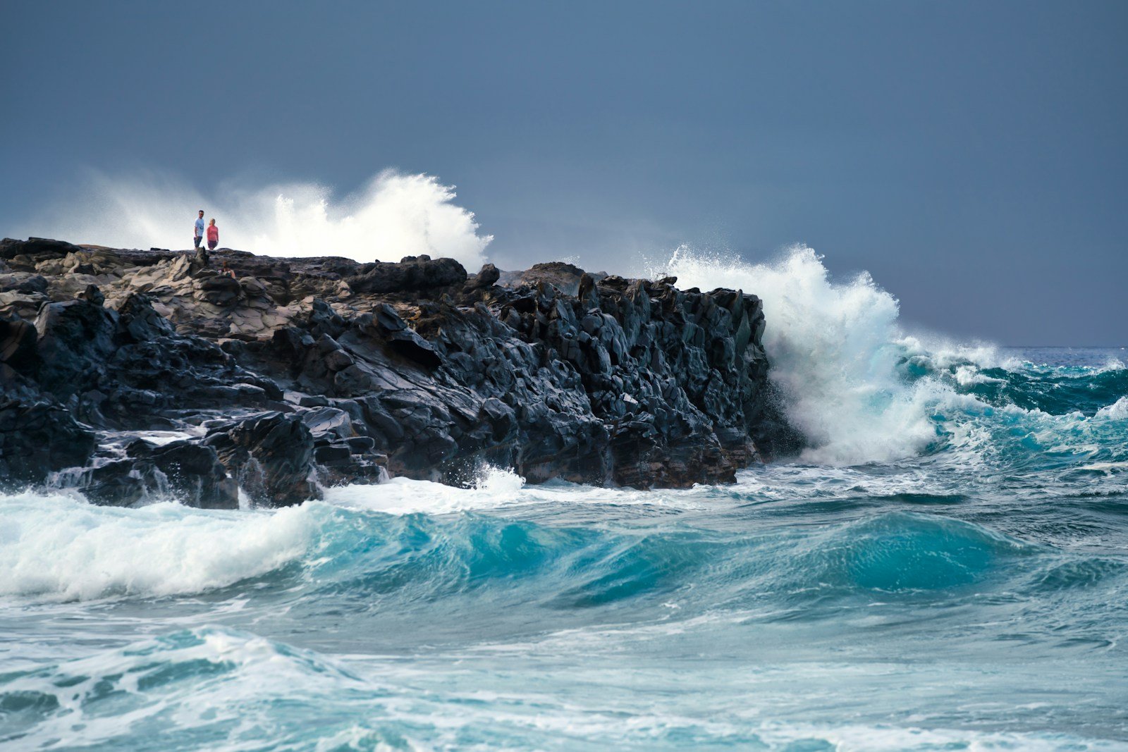 maui natural wonders person in red shirt standing on rock formation near sea waves during daytime
