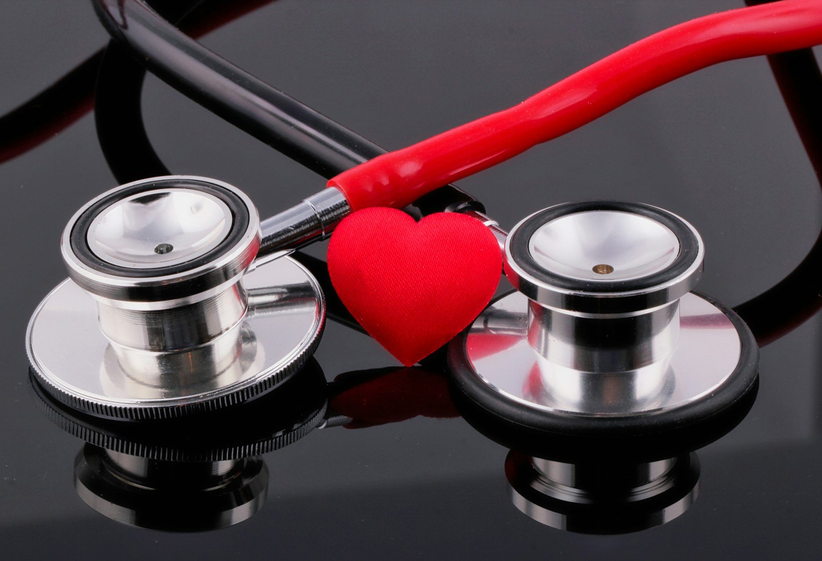 EKTA a stethoscope and a heart on a table