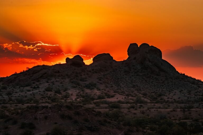 phoenix travel guide The sun is setting over the mountains in the desert