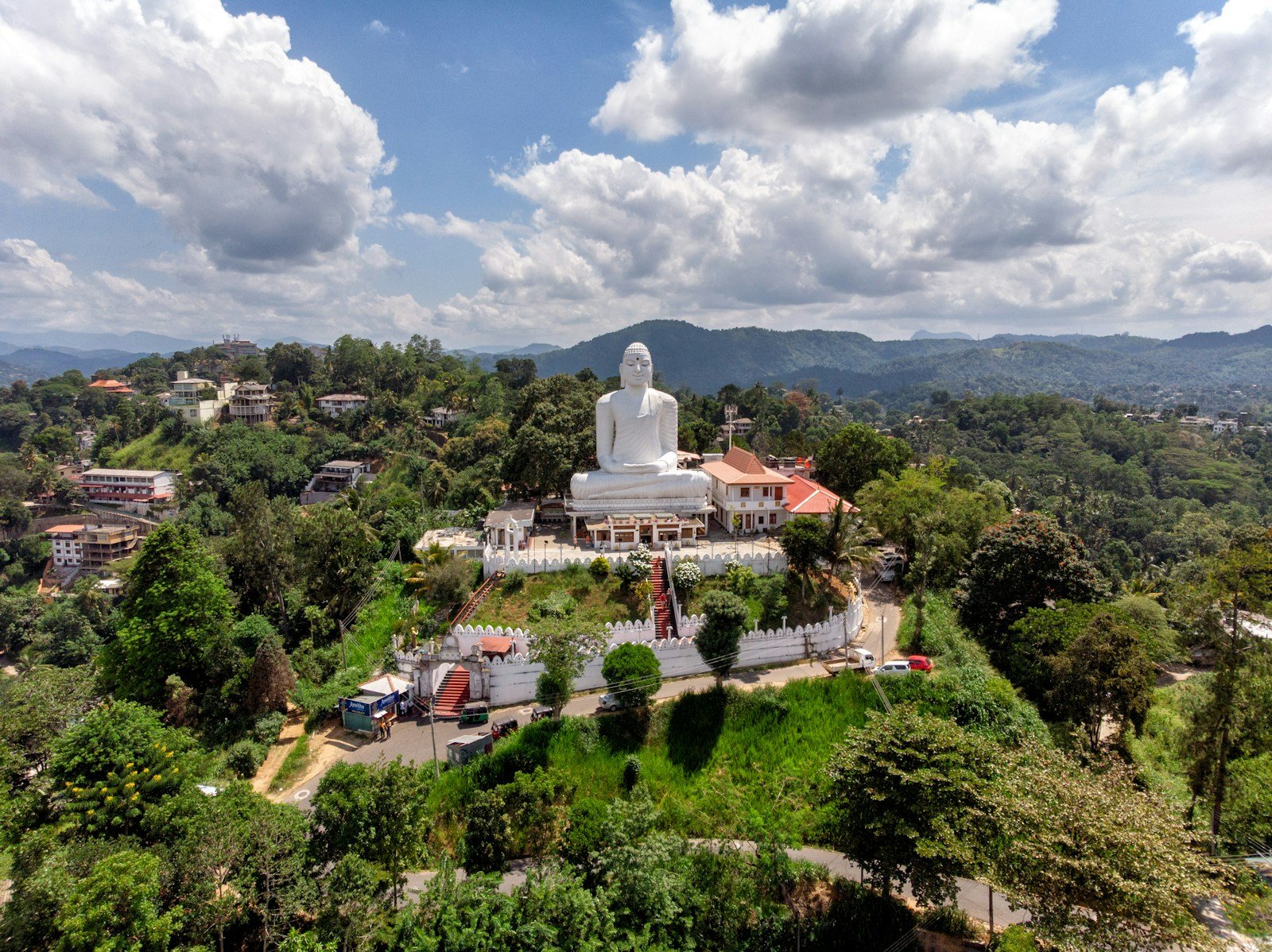 Sri Lanka Travel Guide Gautama Buddha statue under white clouds