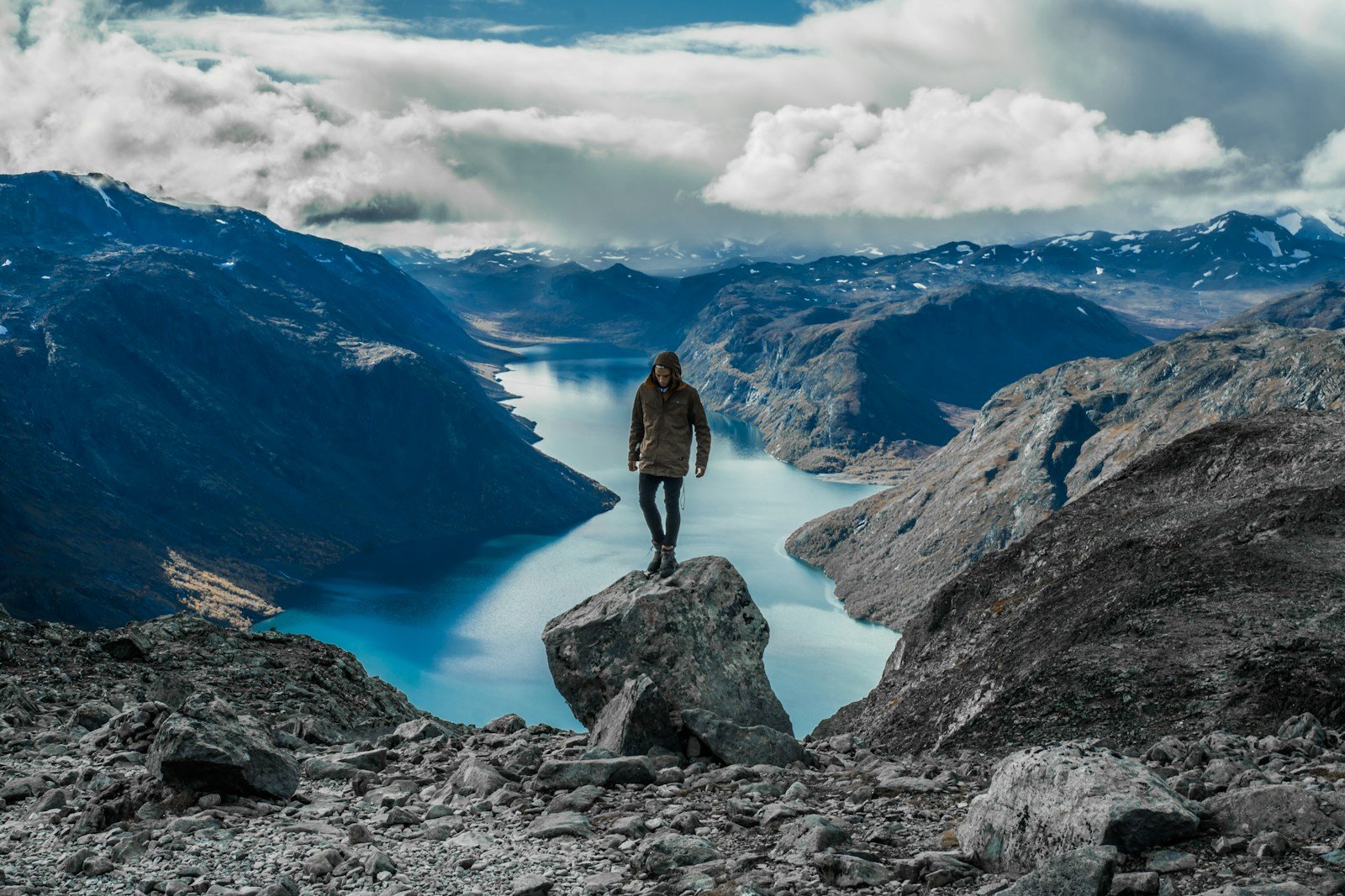 Terms and conditions man standing on gray mountain near lake