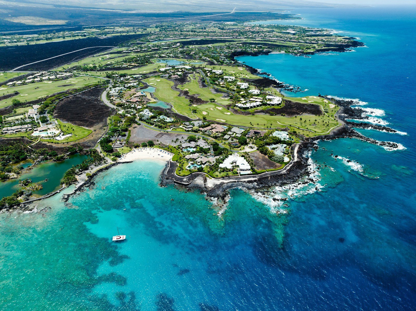 an aerial view of a golf course in the ocean