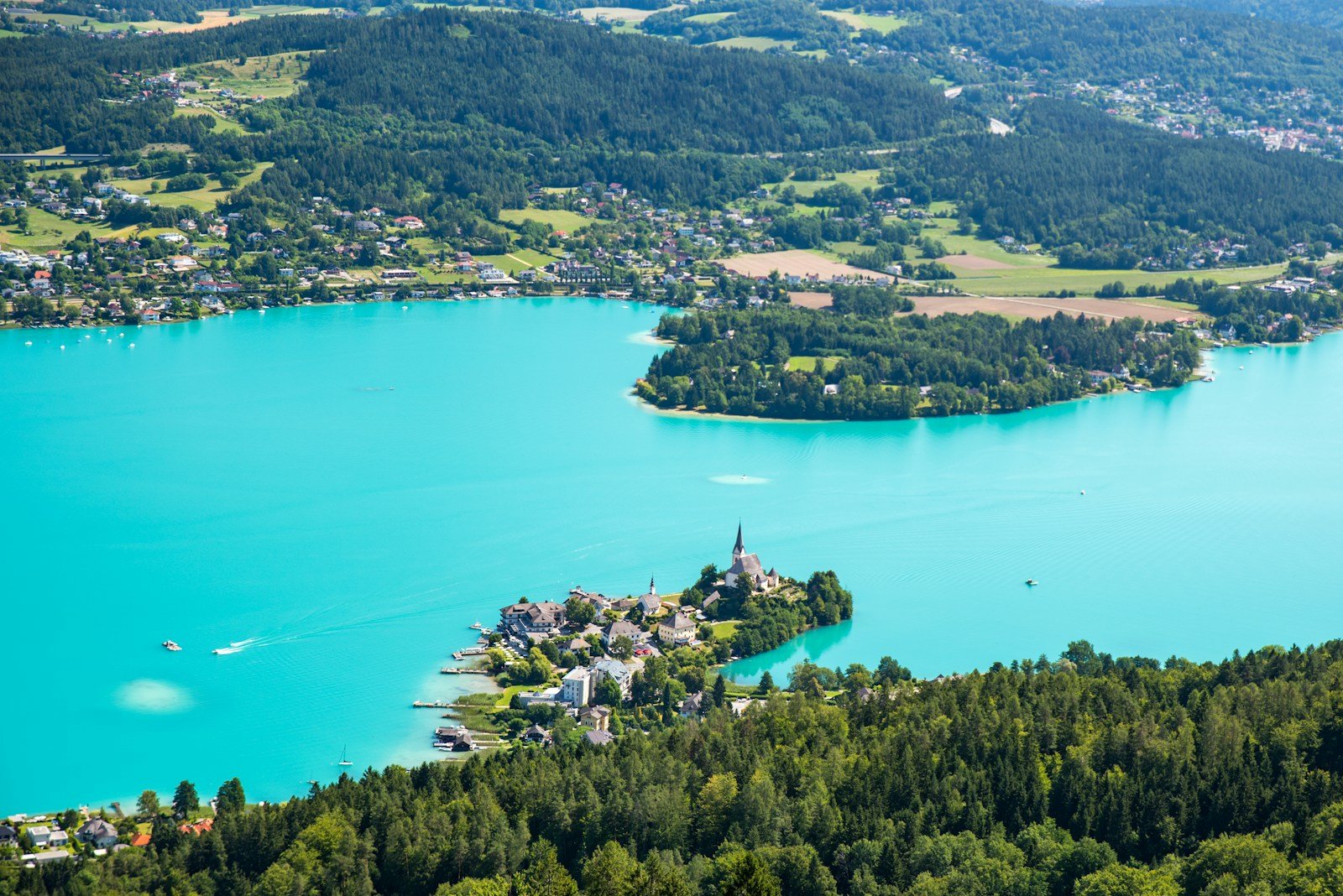 Austria Travel Guide birds eye photography of forest and body of water