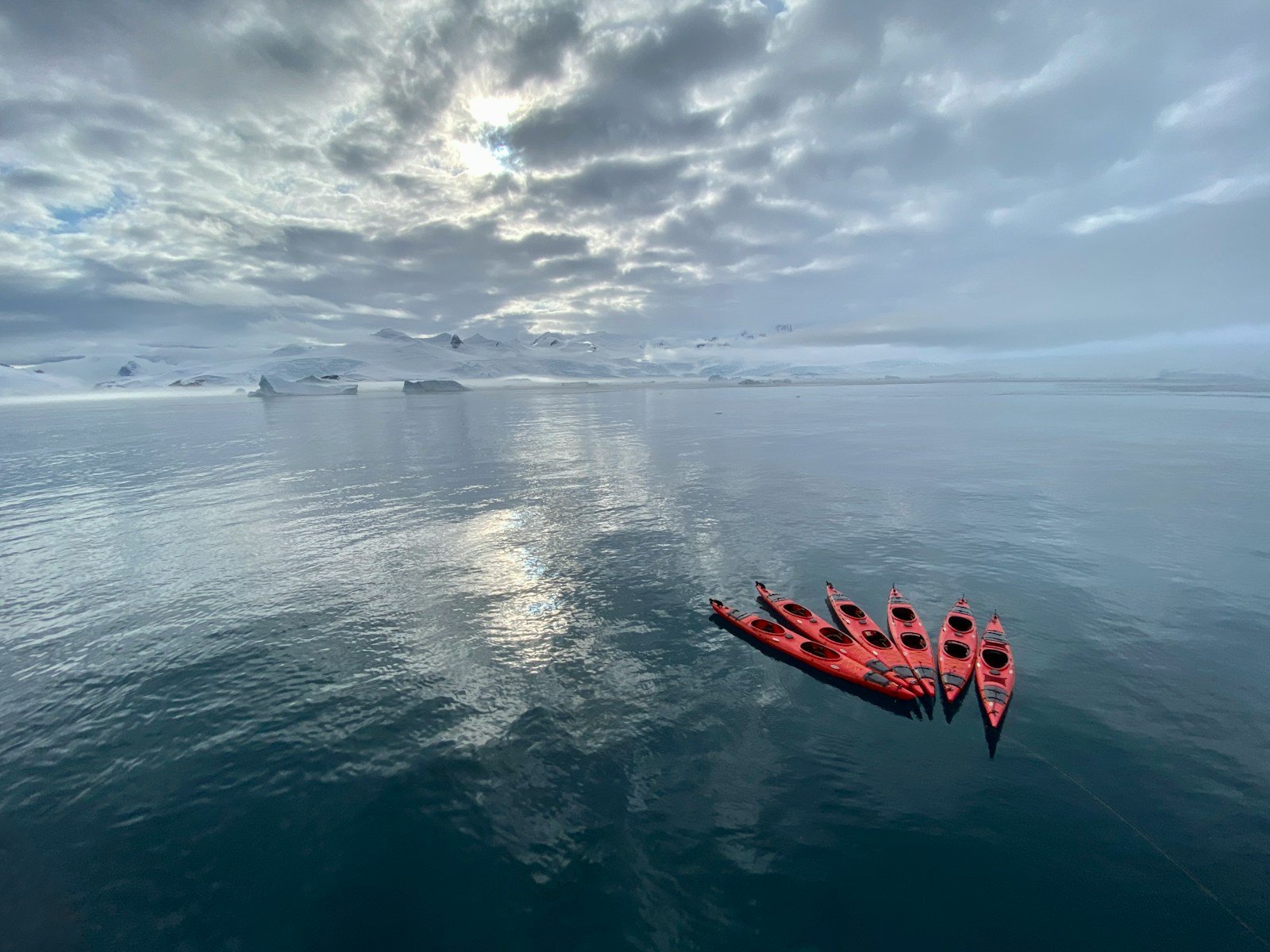 red kayak on blue sea under blue sky during daytime