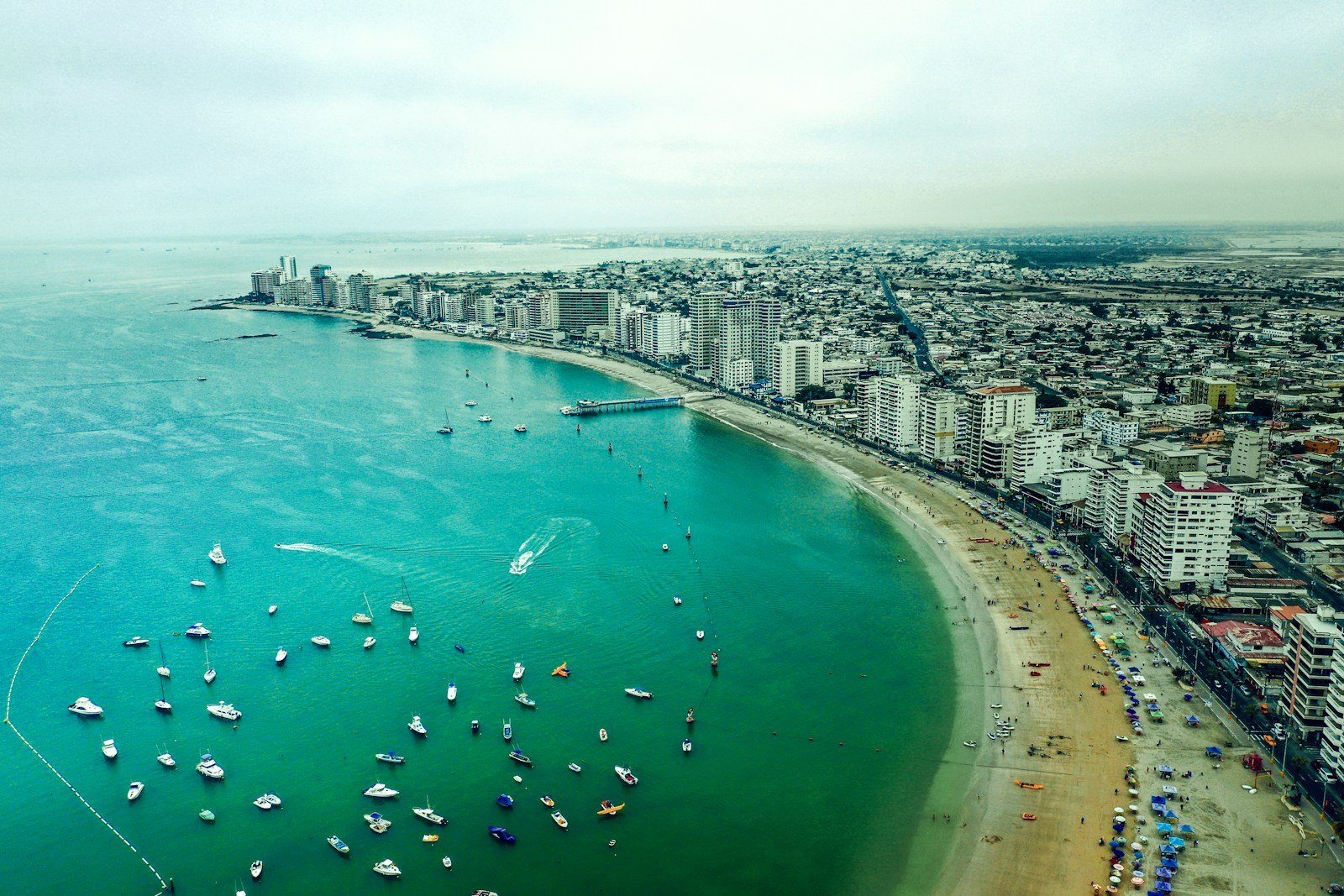 ecuador travel guide aerial view of boats on sea near city buildings during daytime