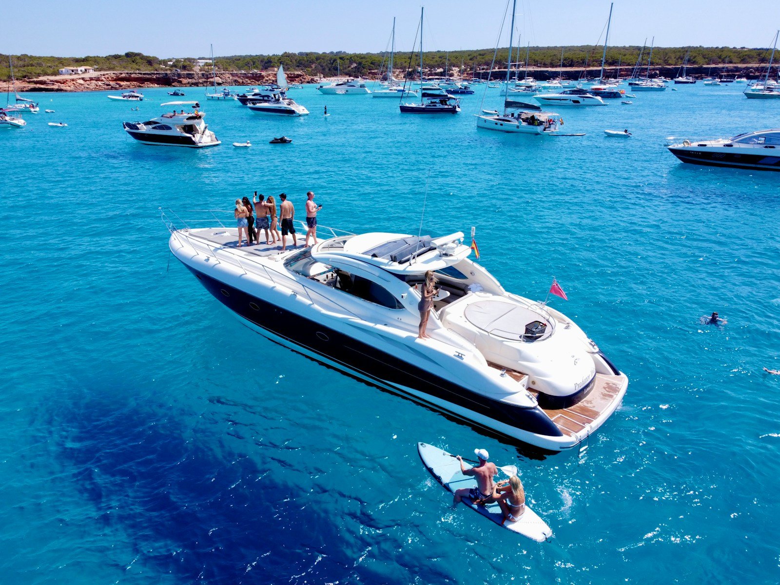 yachts a group of people standing on a boat in the water
