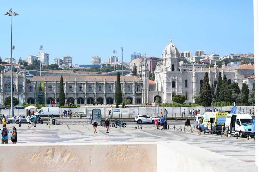 a large building with a courtyard and people walking around