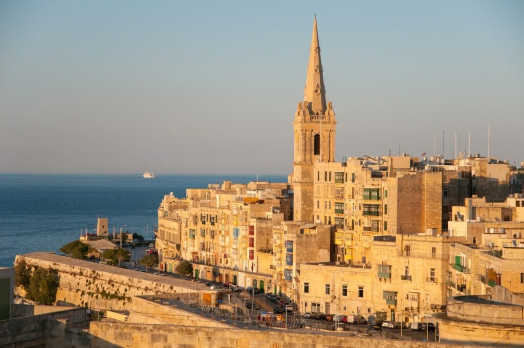 Valletta, Malta brown concrete cathedral near sea during daytime