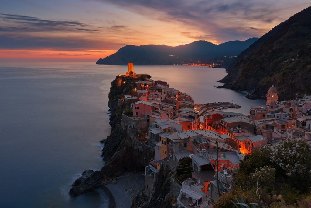 Cinque Terre aerial view of village on mountain cliff during orange sunset