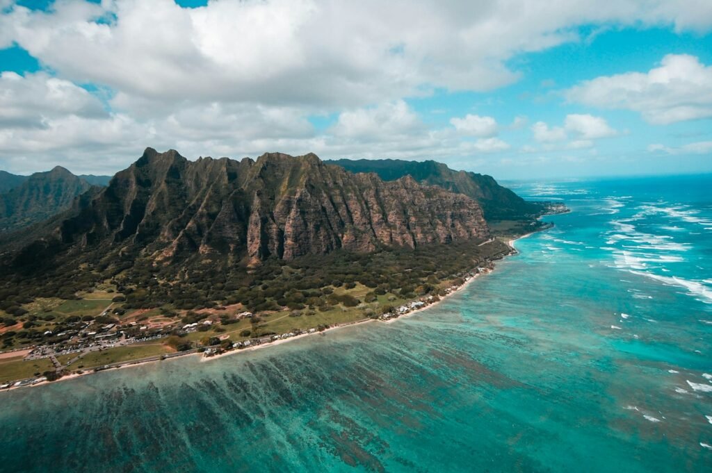 Honolulu, USA island surround by green sea under cloudy sky