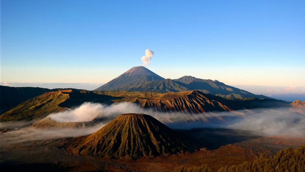 Indonesia Travel Guide brown and black mountain under blue sky during daytime