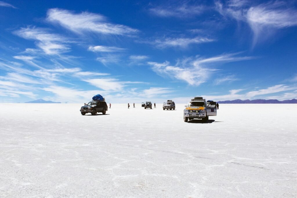 Uyuni Salt Flat, Bolivia
sports utility vehicles on desert under cloudy blue sky during daytime