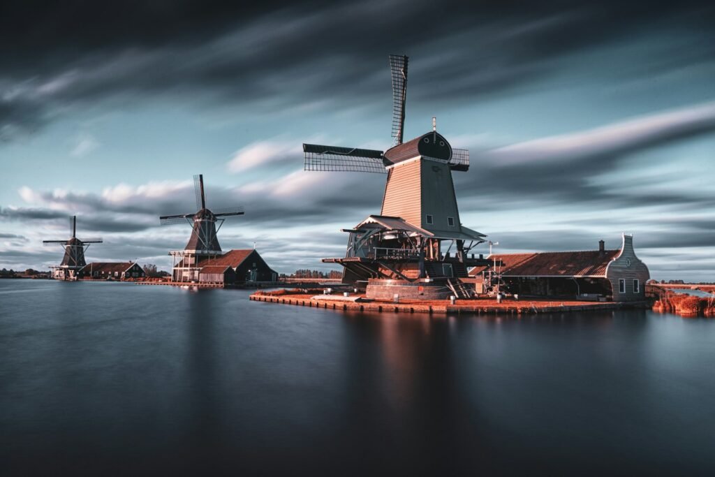 Zaanse Schans, Zaanstad, Netherlands
three windmills by the lake under grey cloudy sky