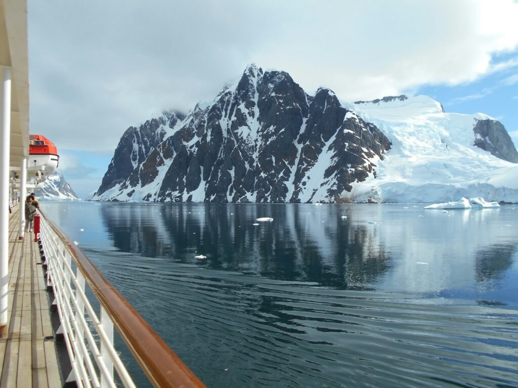 a cruise ship with a mountain in the background