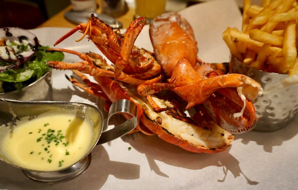 anguilla tours a plate of food with a crab and fries