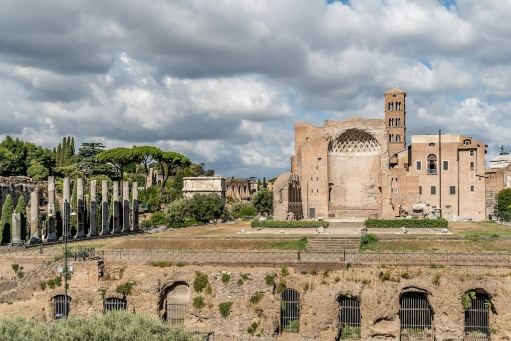 Palatine Hill a stone building with a stone wall with Roman Forum in the background