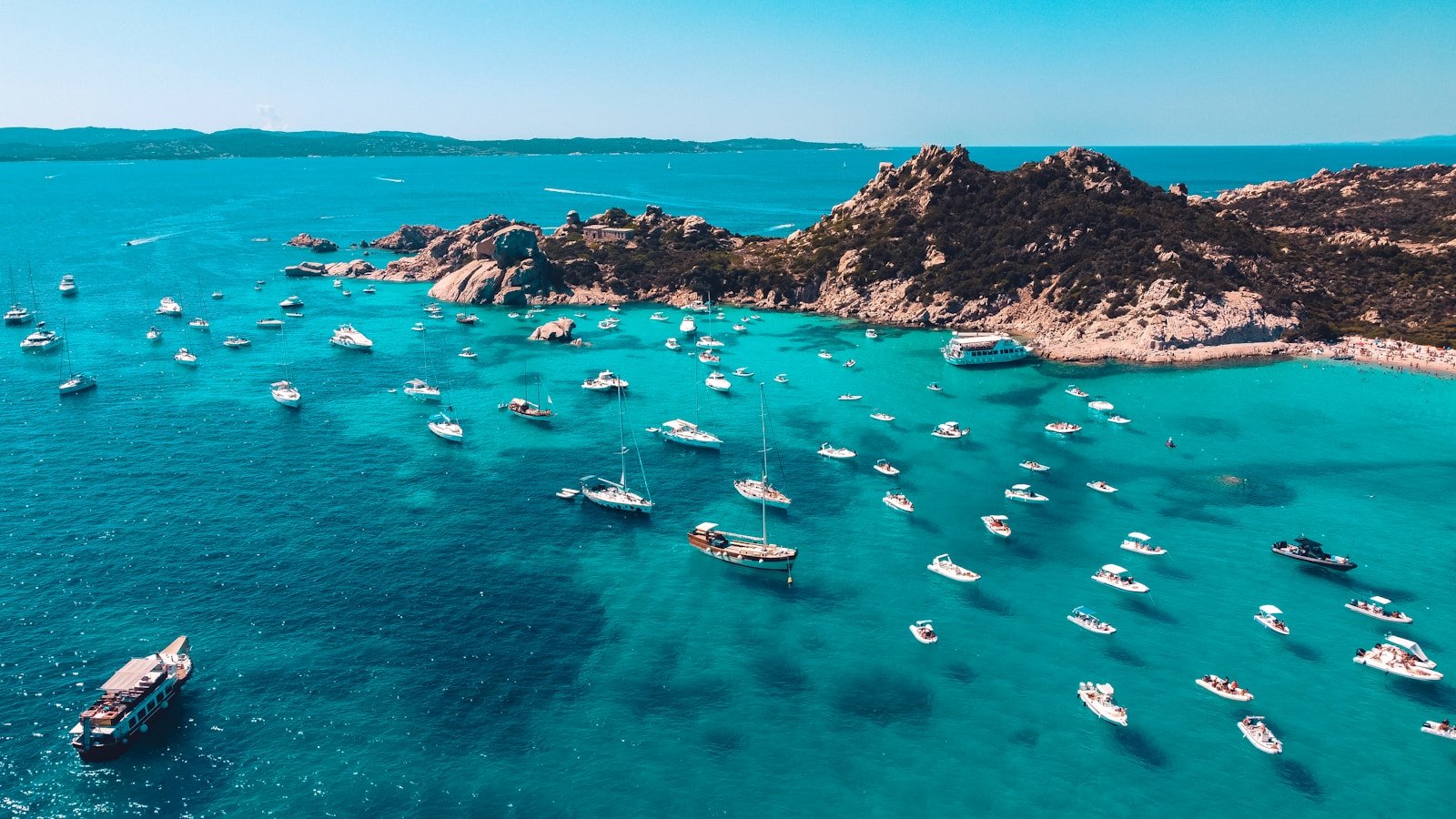 viator Sardinia, Italy a group of boats floating on top of a body of water