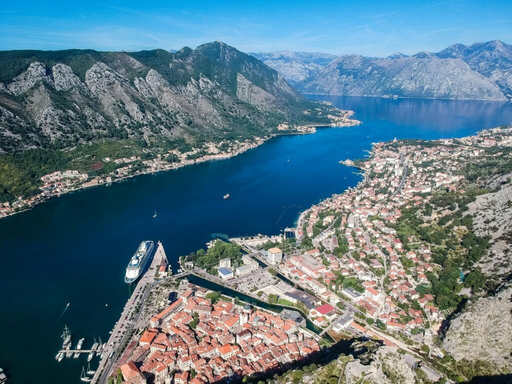Kotor, Черногория aerial view of city near body of water during daytime