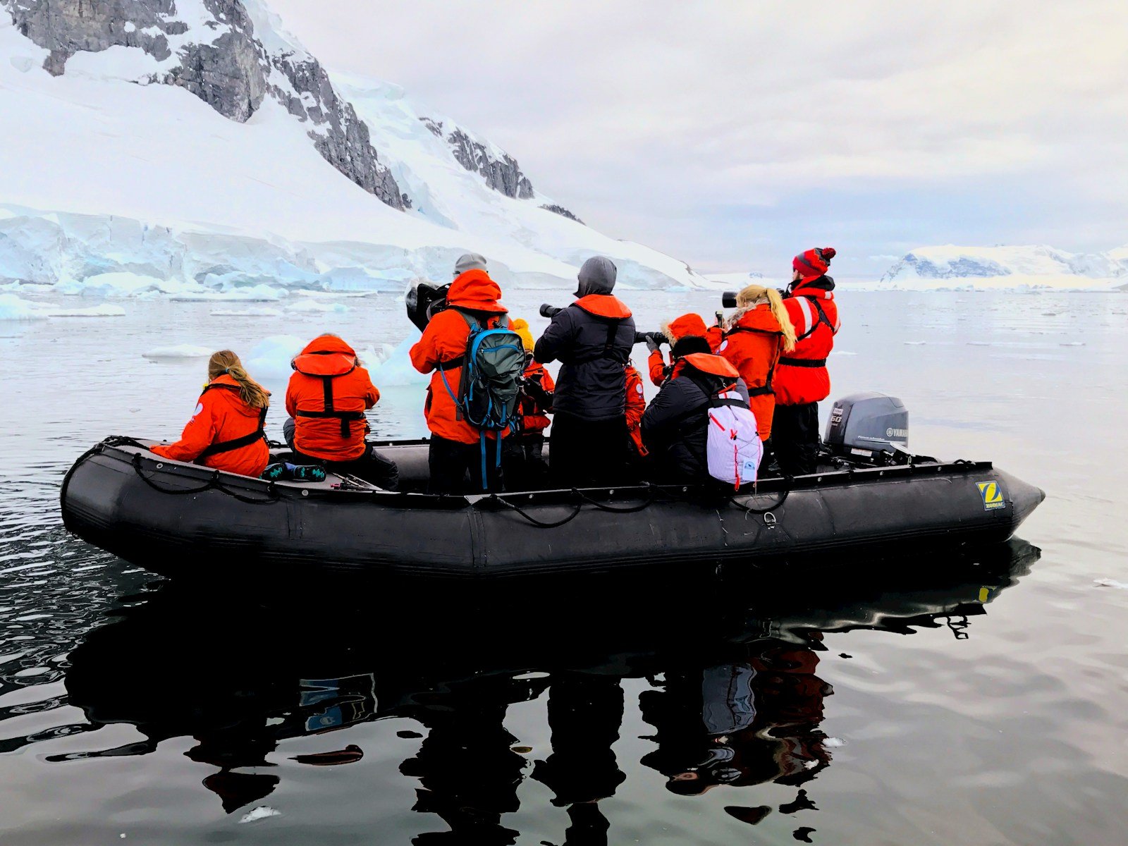 a group of people in an inflatable boat in the water