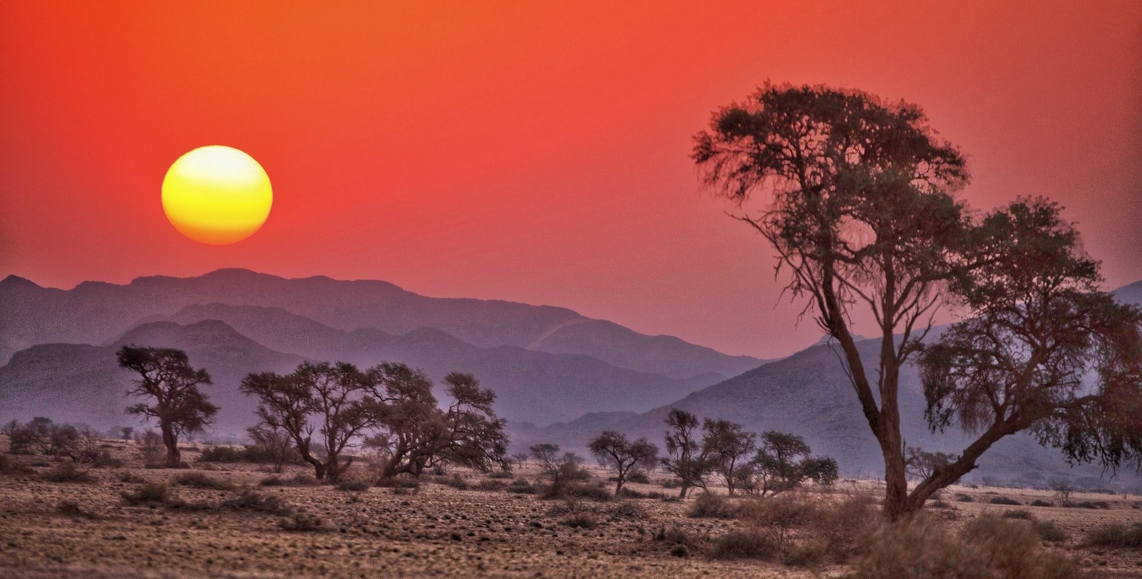 namibia tours the sun is setting over the mountains in the desert