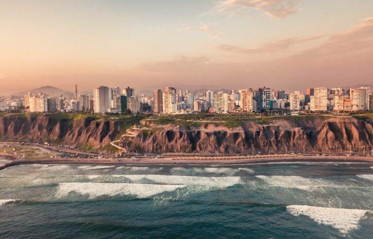 peru travel guide road near body of water and buildings at daytime