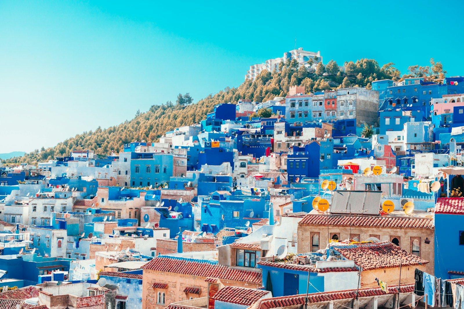 morocco travel guide blue and white painted houses on the cliff