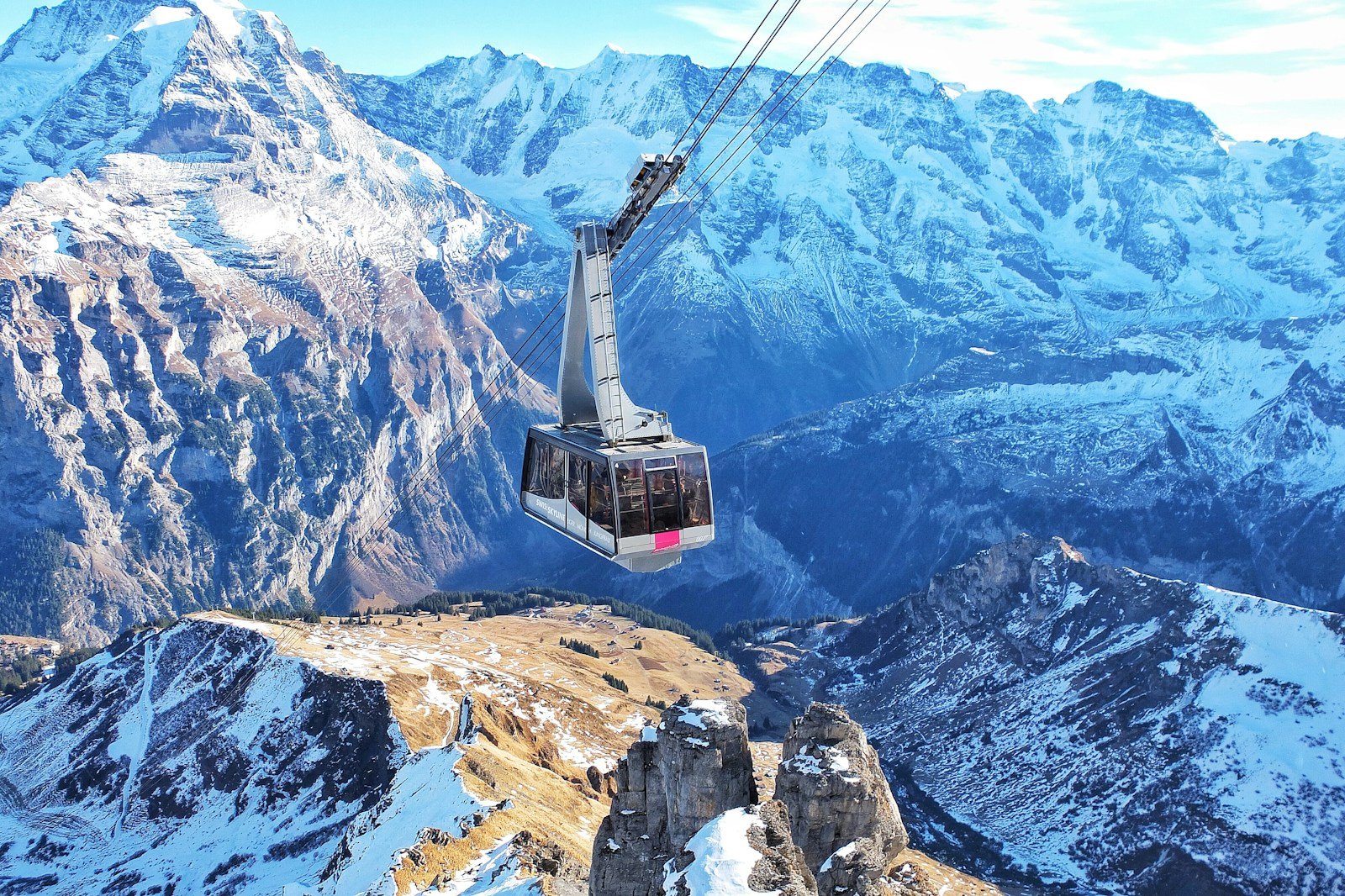 Discover Switzerland bird's eye view of ski lift over mountains during winter