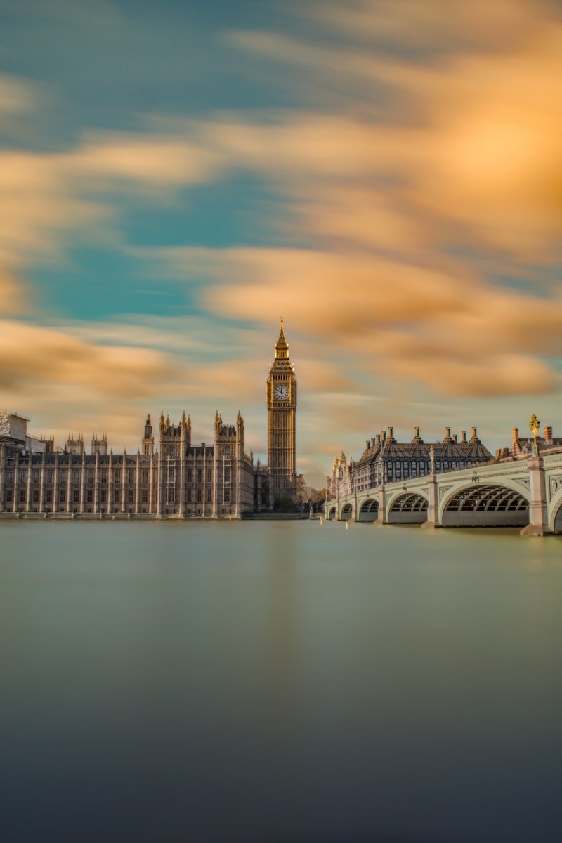 EUROPE TOUR TRAVEL GUIDE brown tower clock under cloudy sy