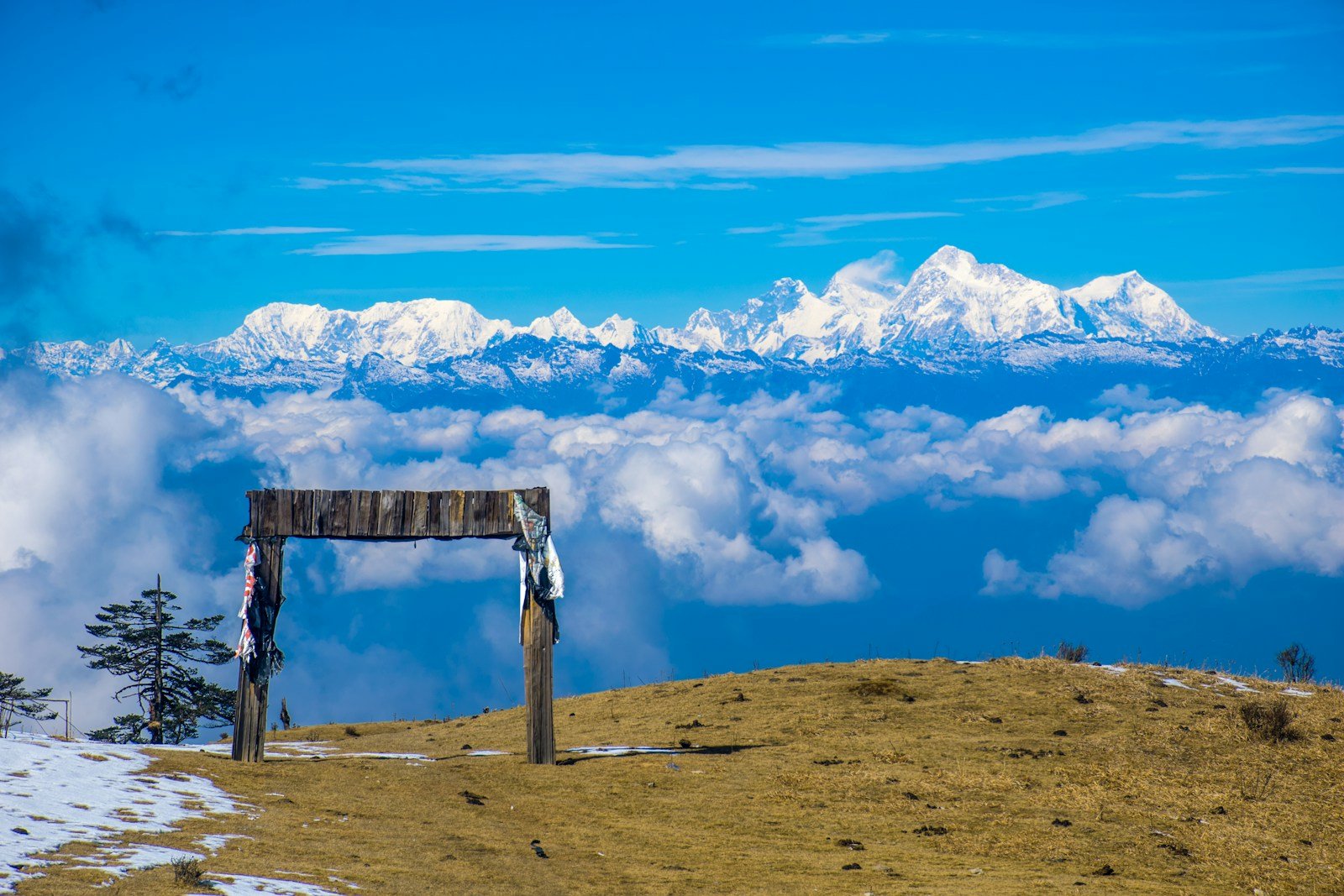 nepal travel guide brown wooden bench on brown field under blue and white cloudy sky during daytime