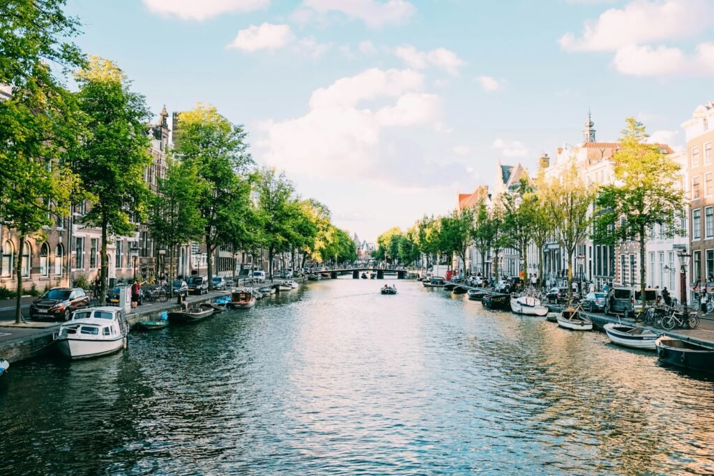amsterdam canal body of water under white sky