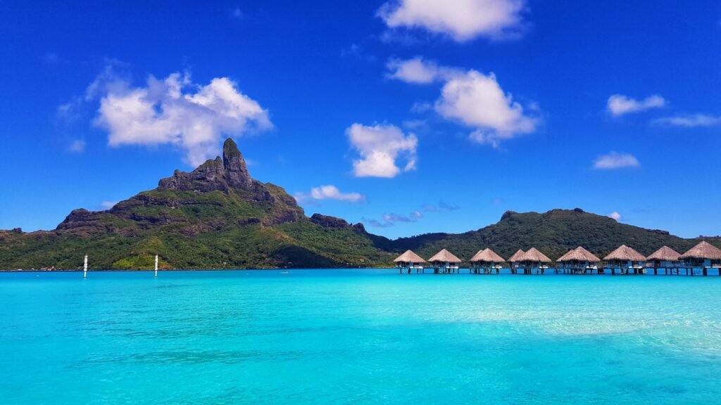 Bora Bora - French Polynesia green mountain beside body of water under blue sky during daytime