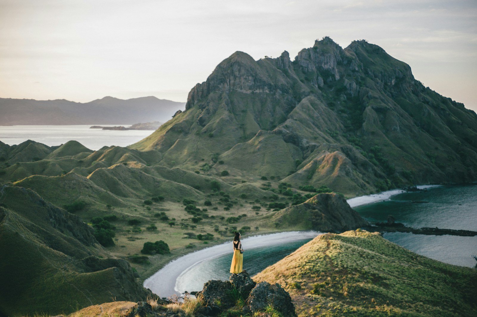 indonesia-travel-guide woman standing on mountain near body of water