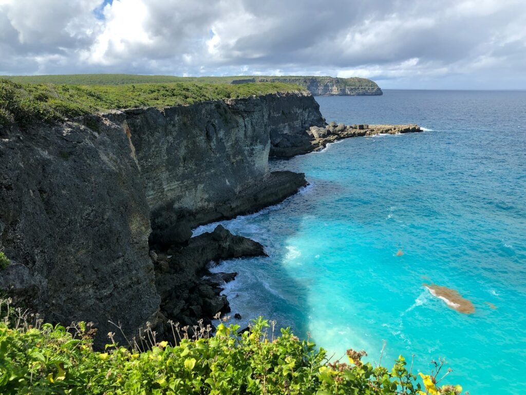 Guadeloupe Travel Guide 1 Guadeloupe travel guide green and brown rocky mountain beside blue sea under blue and white cloudy sky during daytime