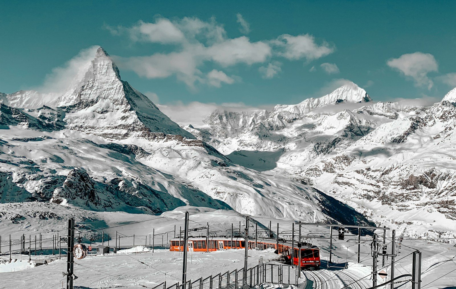 switzerland tours snow covered mountain under blue sky during daytime