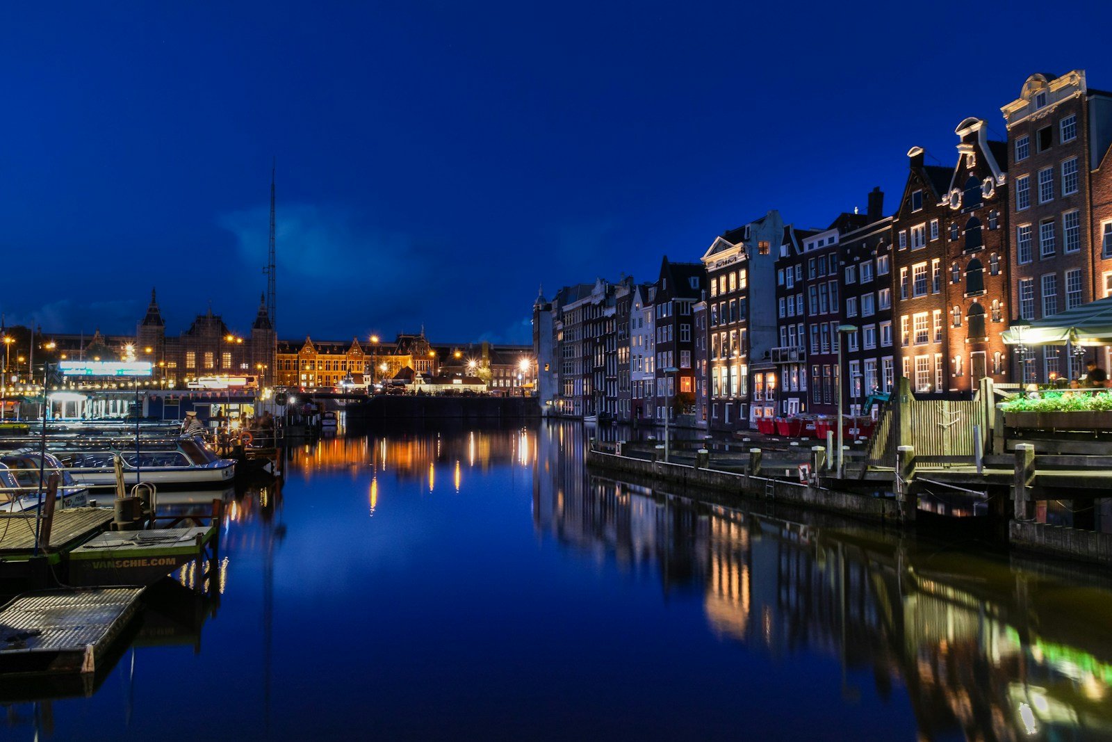 amsterdam travel guide buildings beside body of water during nighttime