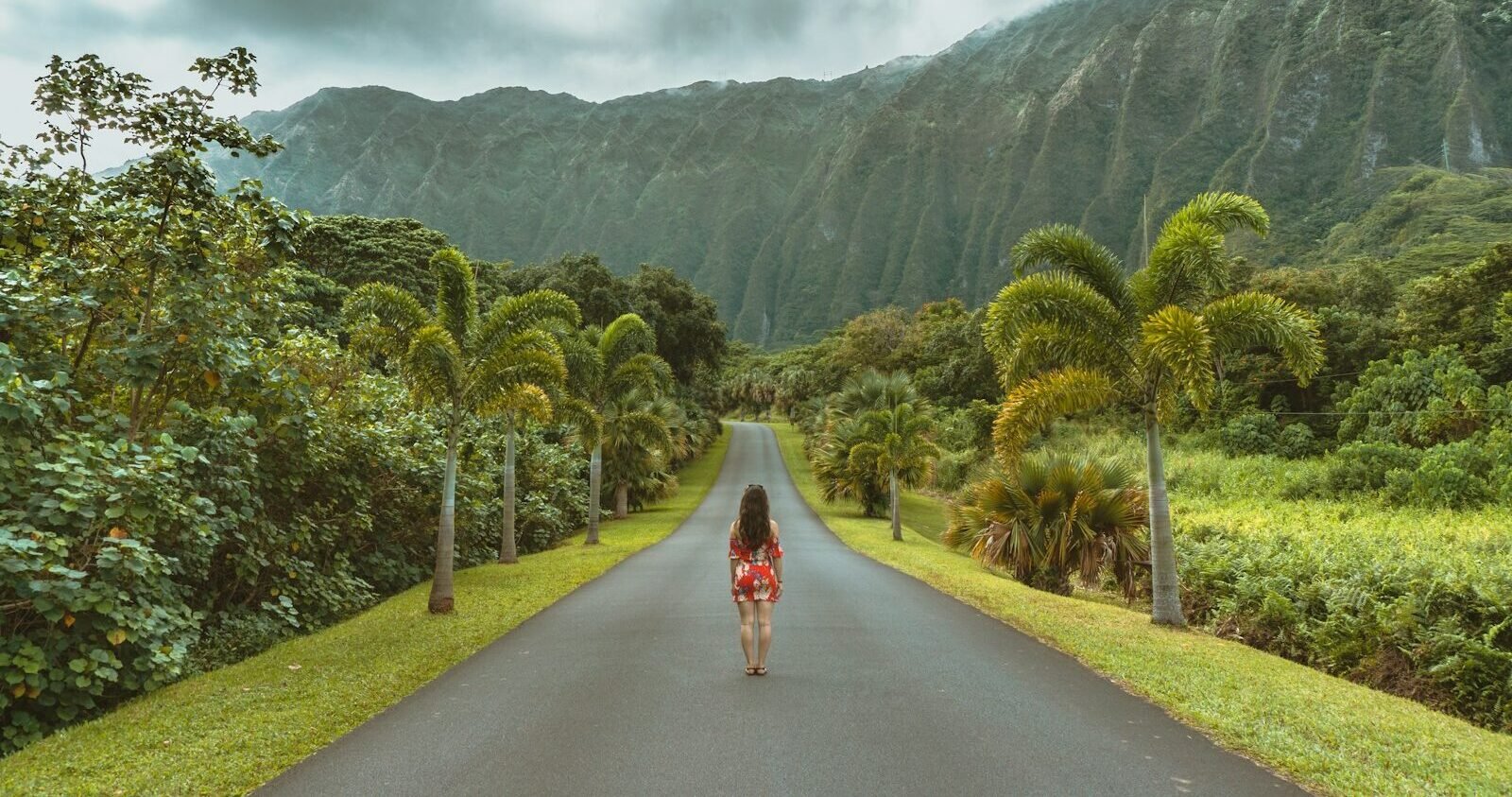 hawaii airlines woman walking in black concrete road in front of mountain